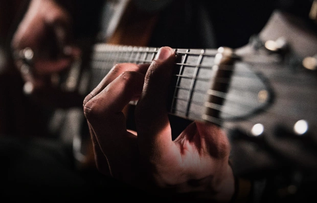 Closeup of a guitar player