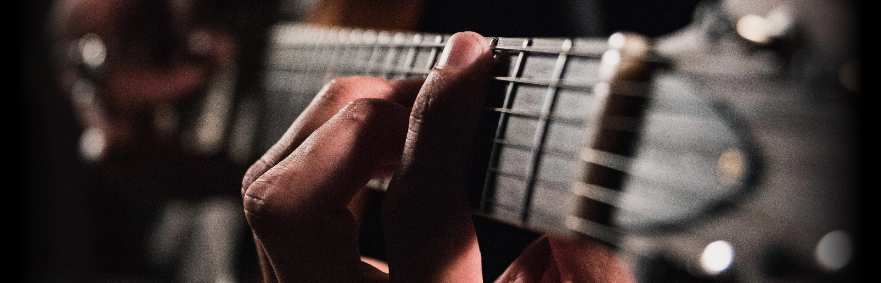 Closeup of a guitar player.